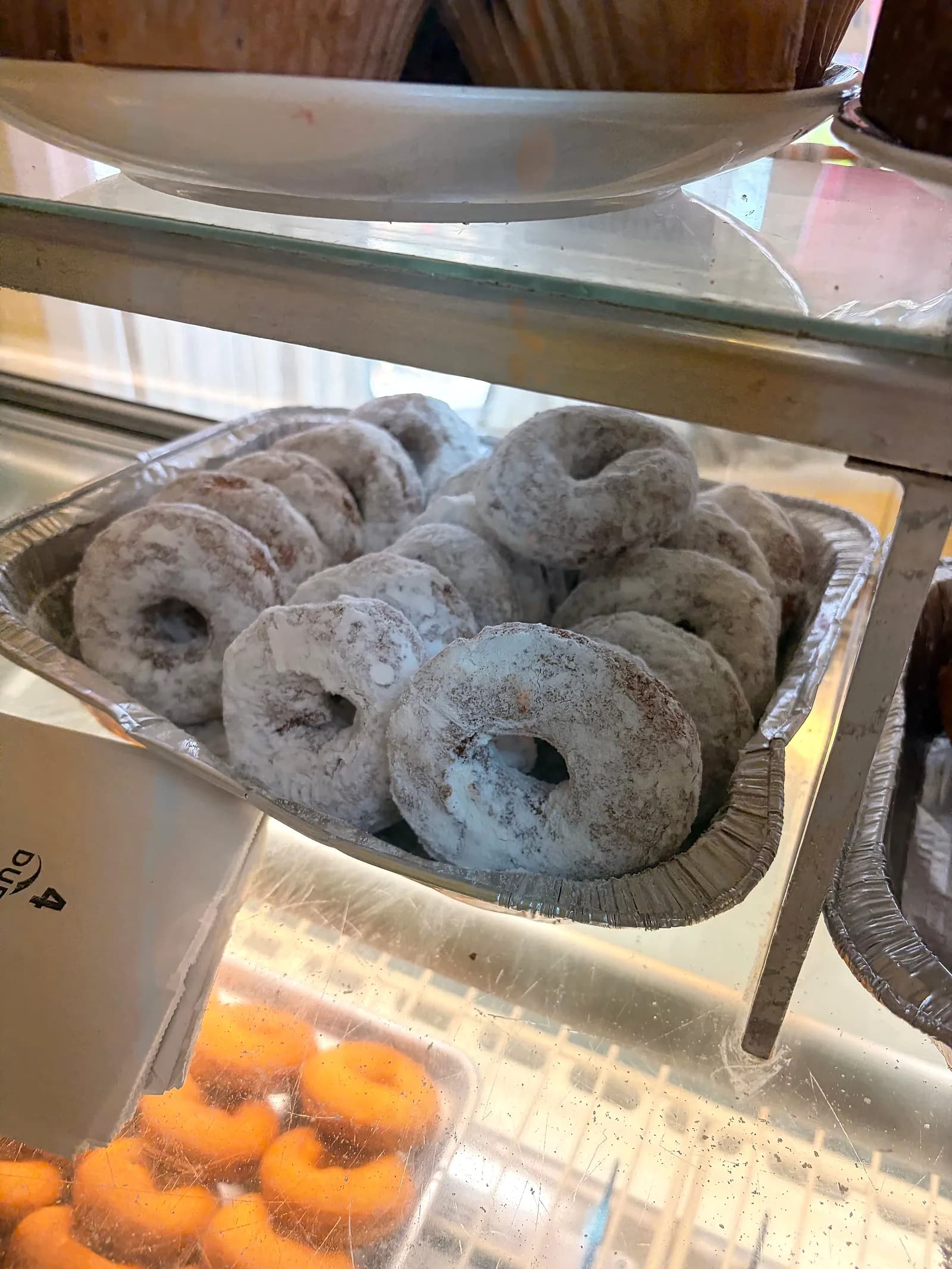 A tray of powdered cake donuts