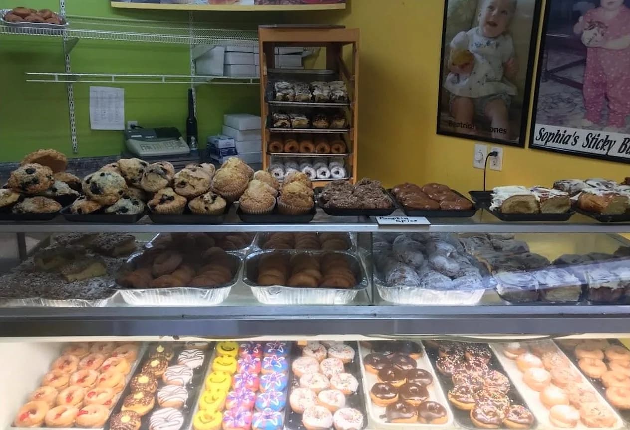 The Marvel's Bakery case — muffins, crumb cake, and rows of fresh donuts