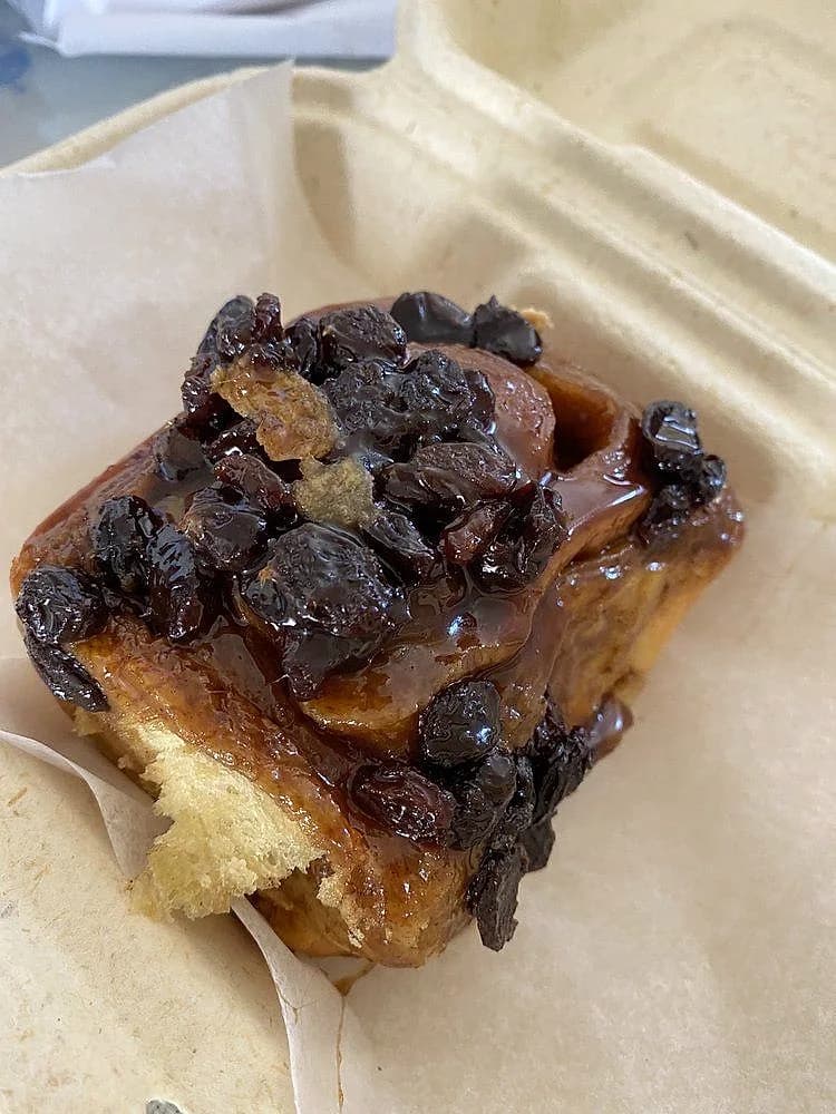 A glazed walnut sticky bun, glistening