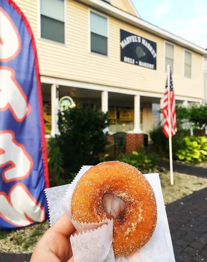 Marvel's storefront on Long Beach Island on a summer morning, a fresh cinnamon-sugar donut in hand